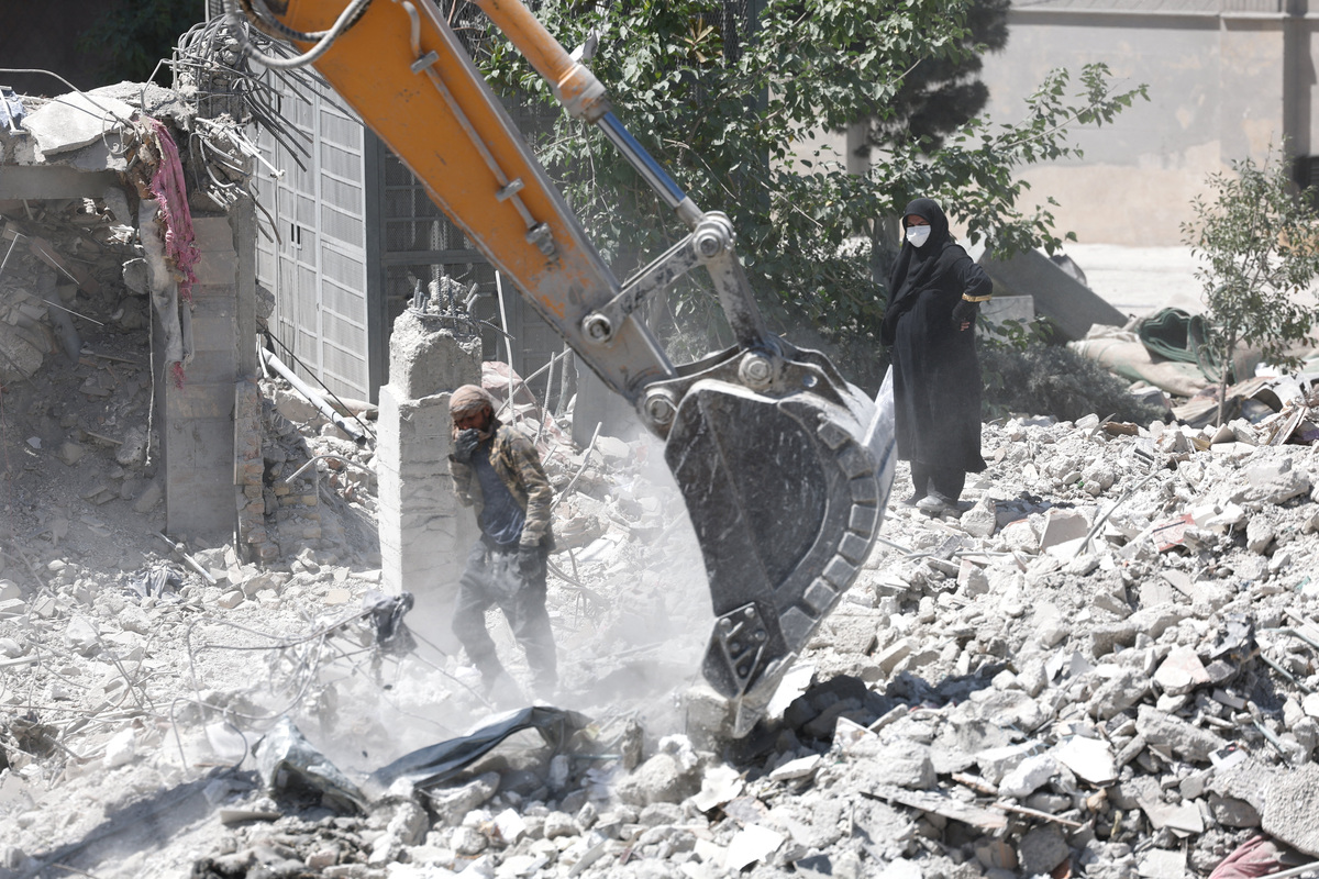 A woman stands among the rubble of her house, which was damaged in a U.S. and Israeli strike in March, in Tehran, Iran June 7, 2026. Majid Asgaripour/WANA (West Asia News Agency) via REUTERS
