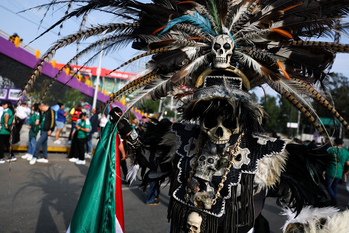 Soccer Football - FIFA World Cup 2026 - Group A - Mexico v South Africa - Estadio Azteca, Mexico City, Mexico - June 11, 2026 Mexico fan poses for a photograph outside the stadium before the match REUTERS/Kai Pfaffenbach