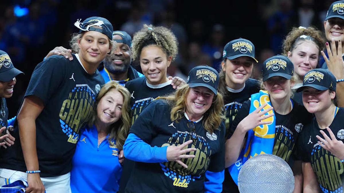  Apr 5, 2026; Phoenix, AZ, USA; UCLA Bruins head coach Cori Close celebrates with players on the podium after defeating the South Carolina Gamecocks during the National Championship game of the women's 2026 NCAA Tournament at Mortgage Matchup Center. Mandatory Credit: Kirby Lee-Imagn Images | Kirby Lee-Imagn Images 