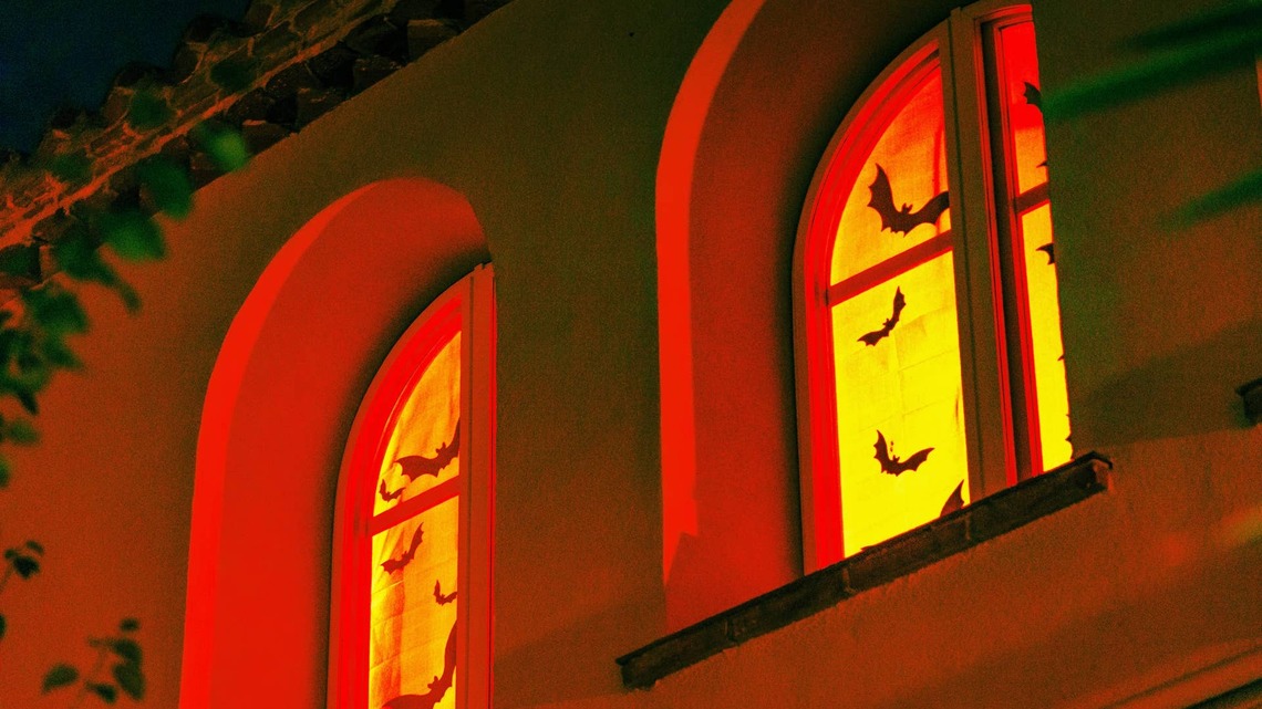 This No-Fail Halloween Window Hack Uses Clings, a Tablecloth, and Lights