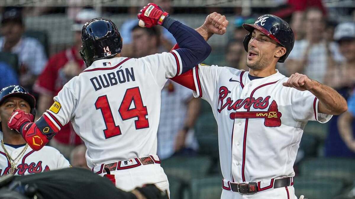 Braves left fielder Mauricio Dubón celebrates with first baseman Matt Olson after hitting a three-run home run during the third inning of a 7-3 victory over the Blue Jays on Wednesday night.