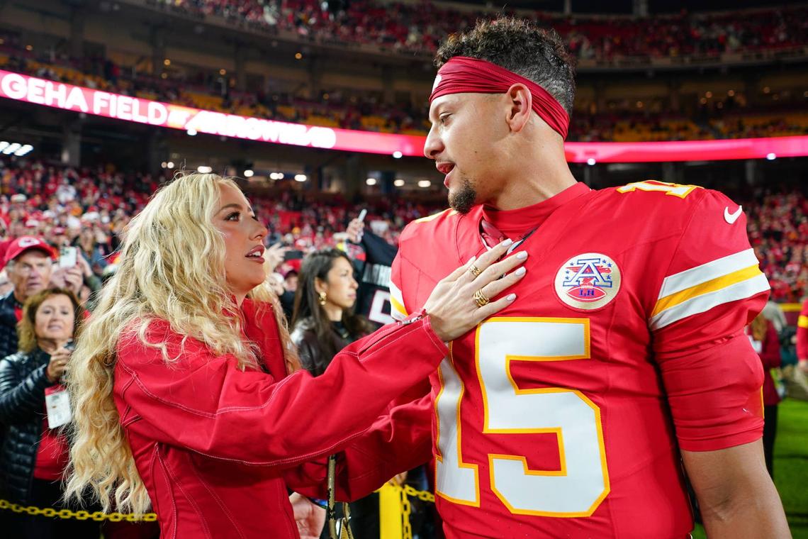  Oct 27, 2025; Kansas City, Missouri, USA; Kansas City Chiefs quarterback Patrick Mahomes (15) greets wife, Brittany Mahomes, during warmups prior to the game against the Washington Commanders at GEHA Field at Arrowhead Stadium. Mandatory Credit: Denny Medley-Imagn Images 