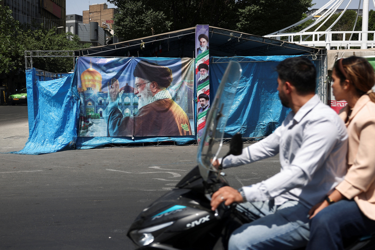 People drive past a banner with a picture of Iran's late Supreme Leader Ayatollah Ali Khamenei, in Tehran, Iran, June 17, 2026. Majid Asgaripour/WANA (West Asia News Agency) via REUTERS