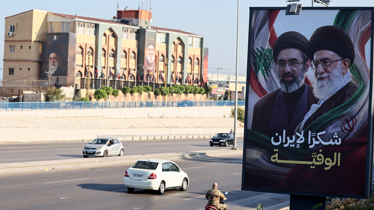Cars drive past billboards showing Iran's new Supreme Leader Ayatollah Mojtaba Khamenei, left, and his late father Ali Khamenei, right, with the slogan "Thank you, loyal Iran," erected along the highway leading to Rafic Hariri International Airport in Beirut on June 22, 2026. Iran and the United States agreed on June 22, to set up communications lines to keep the vital Strait of Hormuz open and end fighting in Lebanon, mediators said, after their first round of talks in Switzerland toward ending the war in the Middle East. Lebanon was drawn into the Middle East war on March 2 when Tehran-backed militant group Hezbollah launched attacks on Israel to avenge the killing of the Iranian leader. Israel has responded with broad strikes across Lebanon and a ground offensive. (Anwar Amro/AFP/Getty Images/TNS)