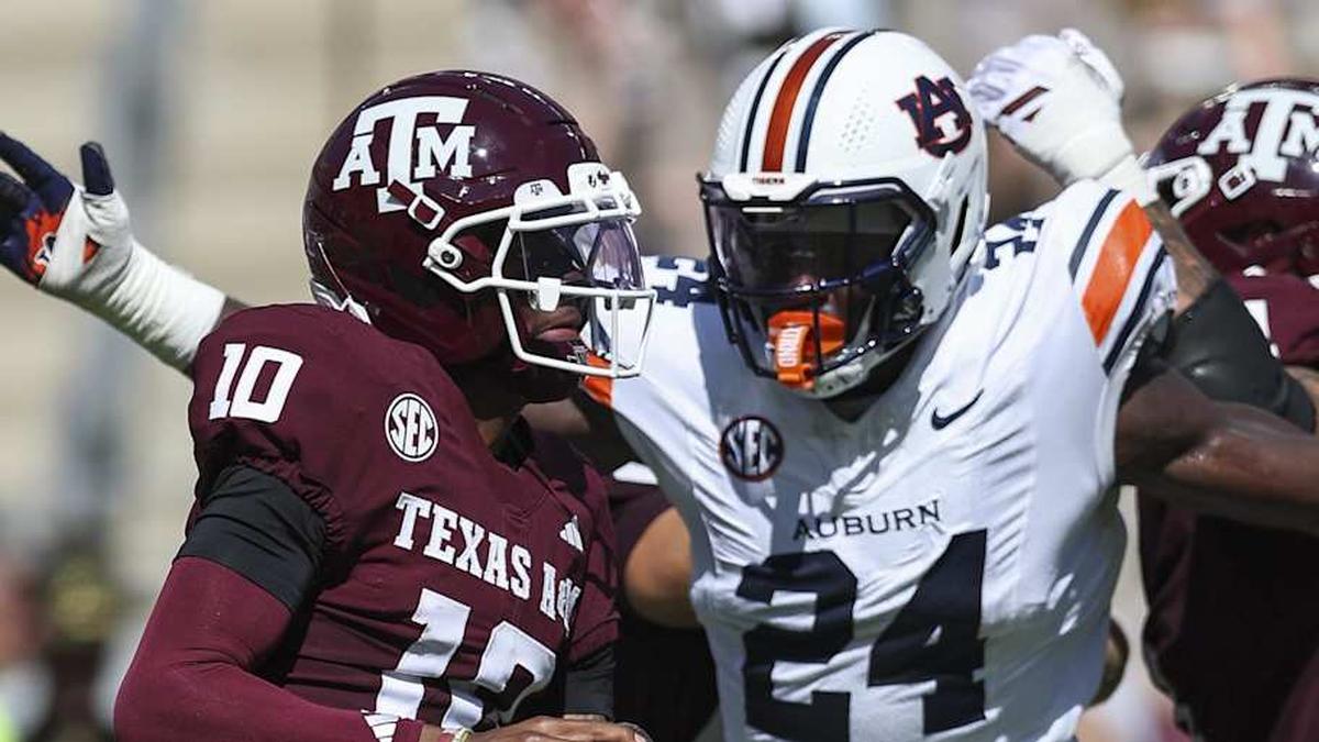  Sep 27, 2025; College Station, Texas, USA; Texas A&M Aggies quarterback Marcel Reed (10) looks for an open receiver as Auburn Tigers defensive end Keyron Crawford (24) applies defensive pressure during the second quarter at Kyle Field. Mandatory Credit: Troy Taormina-Imagn Images | Troy Taormina-Imagn Images 