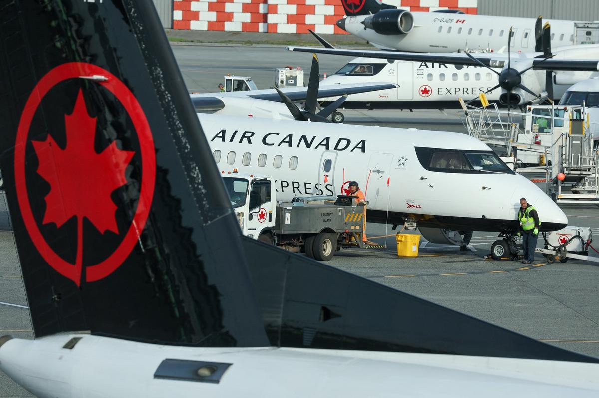 Ground crew service an Air Canada passenger plane at the domestic terminal of Vancouver International Airport in Richmond, British Columbia, Canada May 1, 2026. REUTERS/Chris Helgren