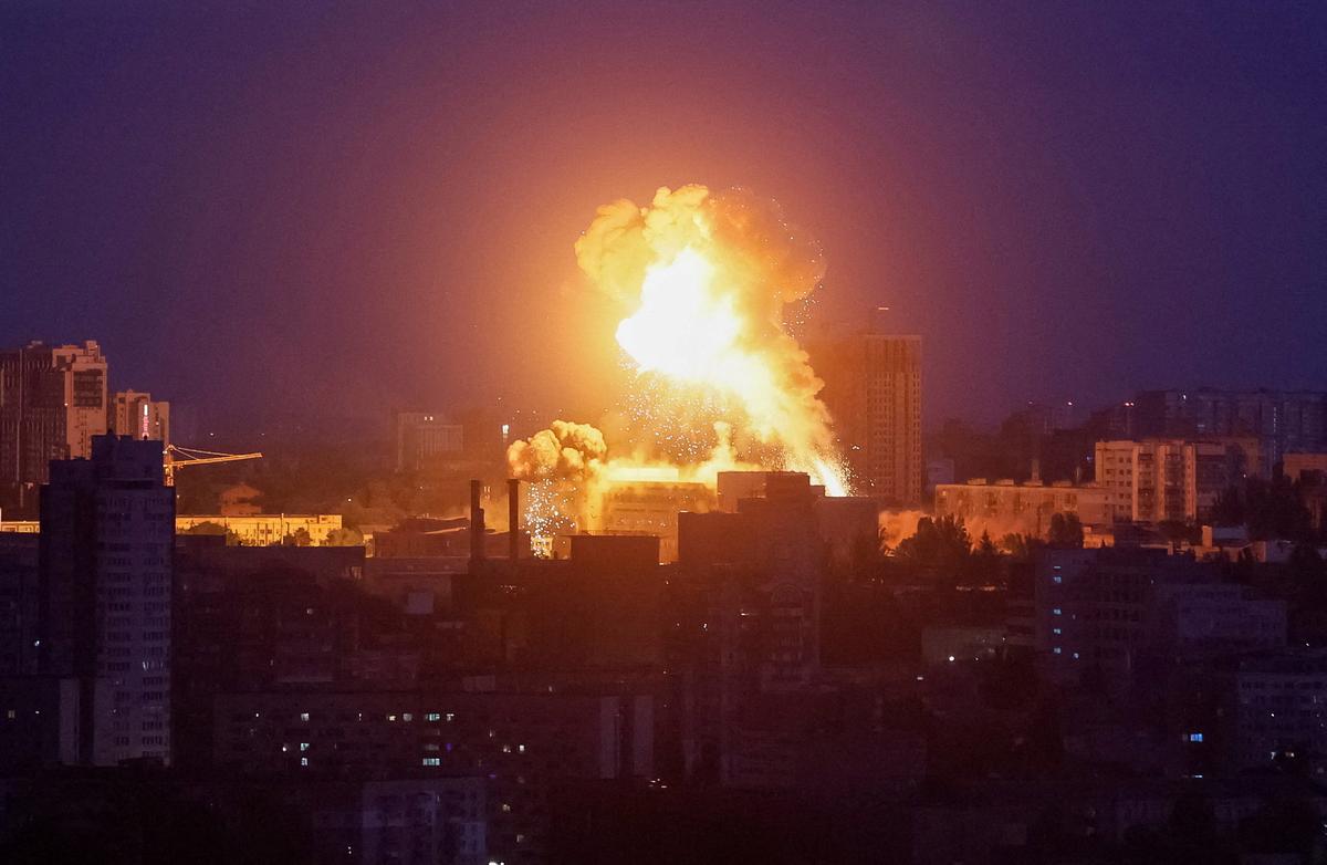 An explosion lights up the sky over the city during a Russian missile and drone strike, amid Russia's attack on Ukraine, in Kyiv, Ukraine May 24, 2026. REUTERS/Gleb Garanich