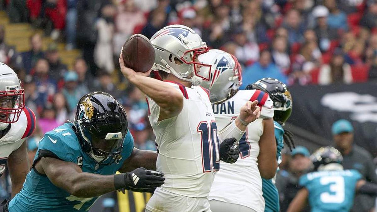  Oct 20, 2024; London, United Kingdom; New England Patriots quarterback Drake Maye (10) throws the ball under pressure from Jacksonville Jaguars defensive end Josh Hines-Allen (41) in the first half during an NFL International Series game at Wembley Stadium. Mandatory Credit: Peter van den Berg-Imagn Images | Peter van den Berg-Imagn Images 