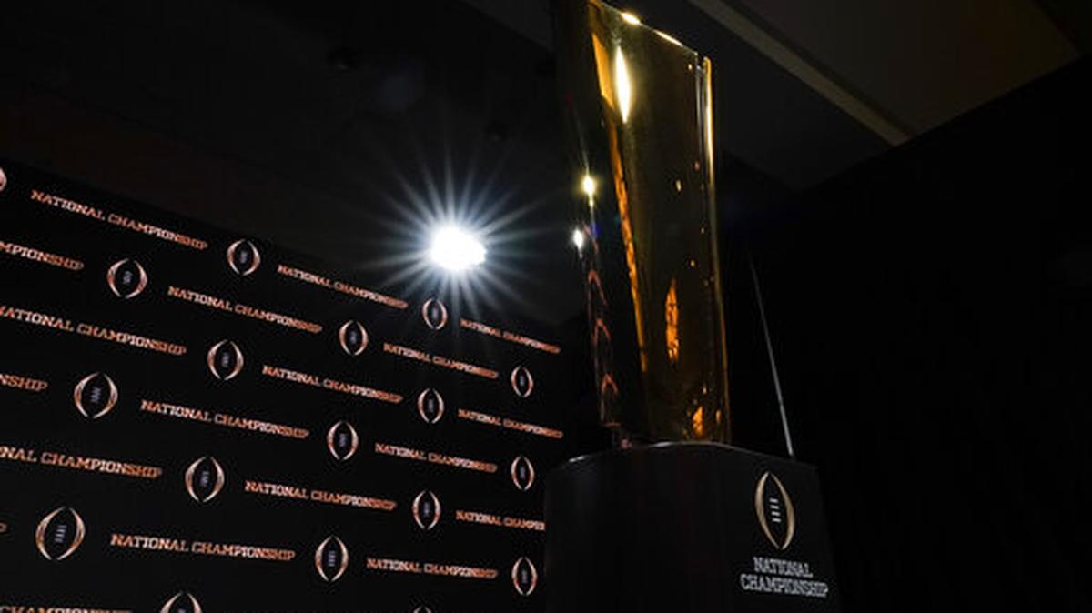 The trophy is displayed before a news conference for the NCAA College Football Playoff national championship game Sunday, Jan. 12, 2020, in New Orleans. Clemson is scheduled to play LSU on Monday.