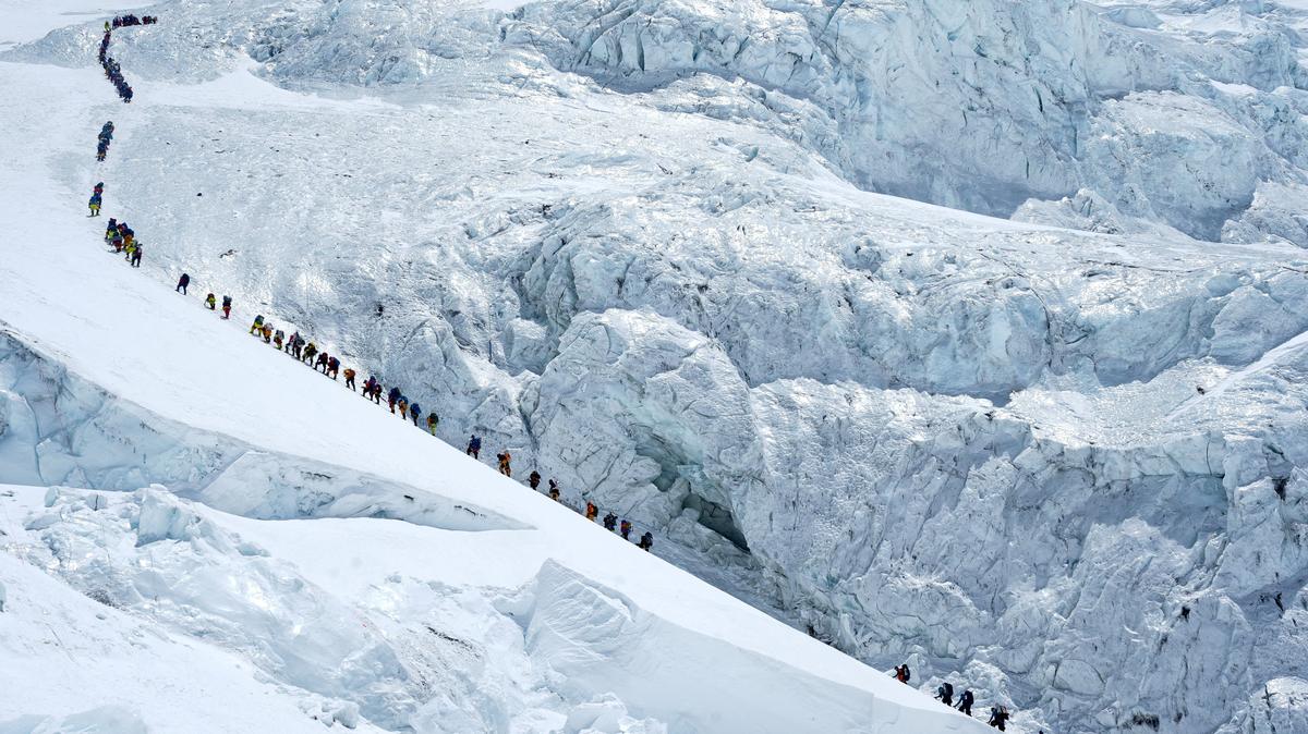 FILE PHOTO: Climbers walk in a long queue as they head to summit Mount Everest in the Solukhumbu district, also known as the Everest region, Nepal, May 18, 2026. REUTERS/Purnima Shrestha/File Photo