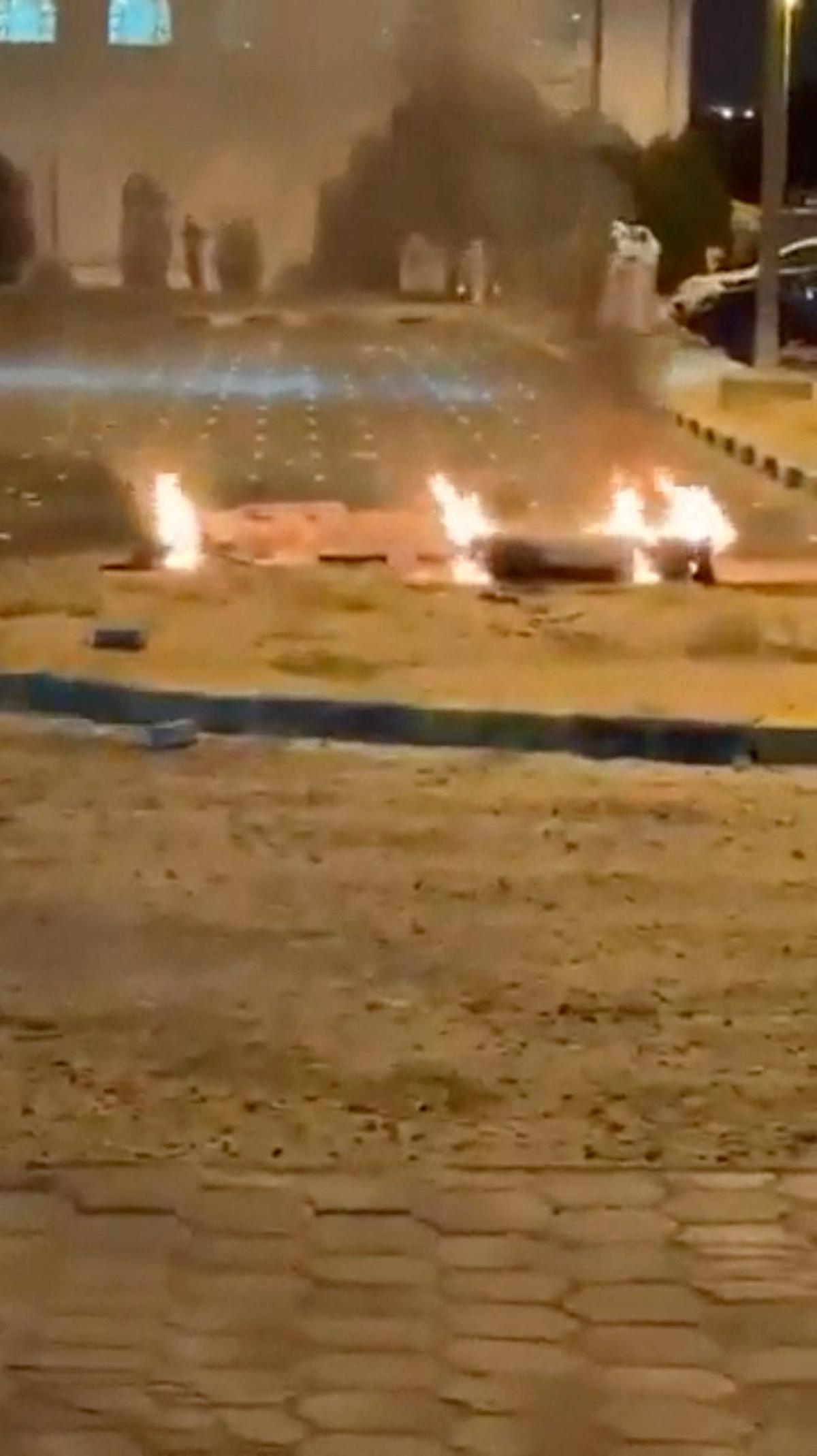 Debris burns on the ground in a parking lot following reports of missile and drone attacks, in Sabah Al Nasser, Kuwait June 3, 2026, in this screengrab obtained from a social media video . SOCIAL MEDIA/via REUTERS