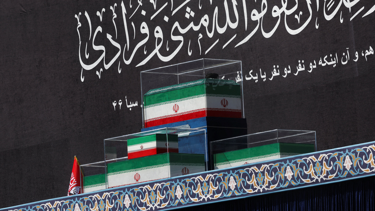 At the Imam Khomeini Grand Mosalla in Tehran, Iran, the coffins of Iran's late Supreme Leader Ayatollah Ali Khamenei and his family members are draped in the colors of Iranian flags on the stage, as people pay their respects on July 4, 2026, to Khamenei, who was killed on Feb. 28 in Israeli and U.S. airstrikes.