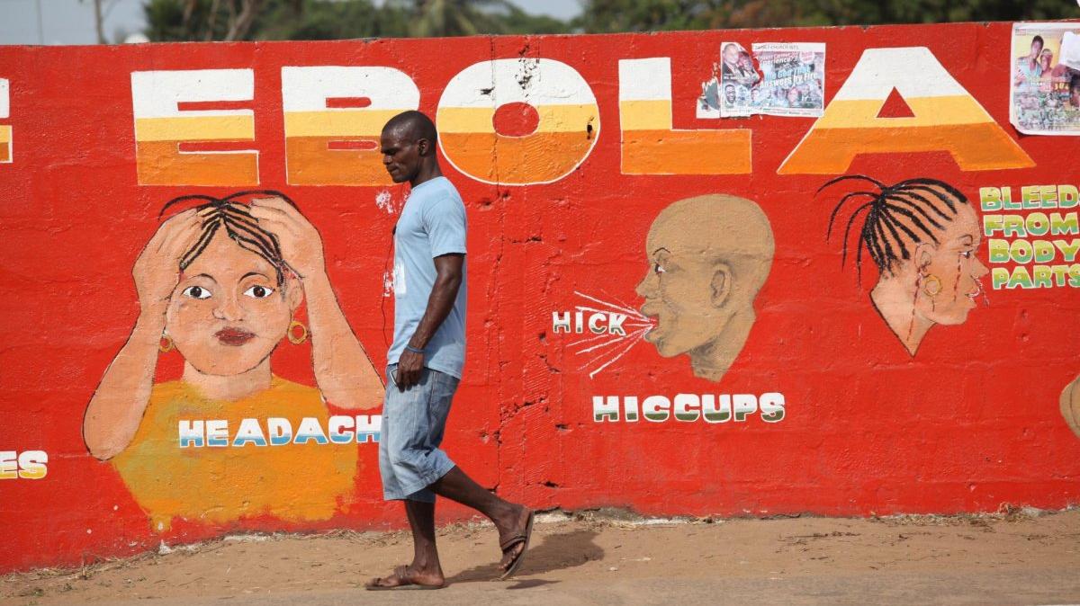 A Liberian man walk pass an ebola awareness painting on a wall in downtown Monrovia, Liberia, in 2015. The United States wants to build a quarantine facility for exposed Americans in Kenya. File Photo by Ahmed Jallanzo/EPA