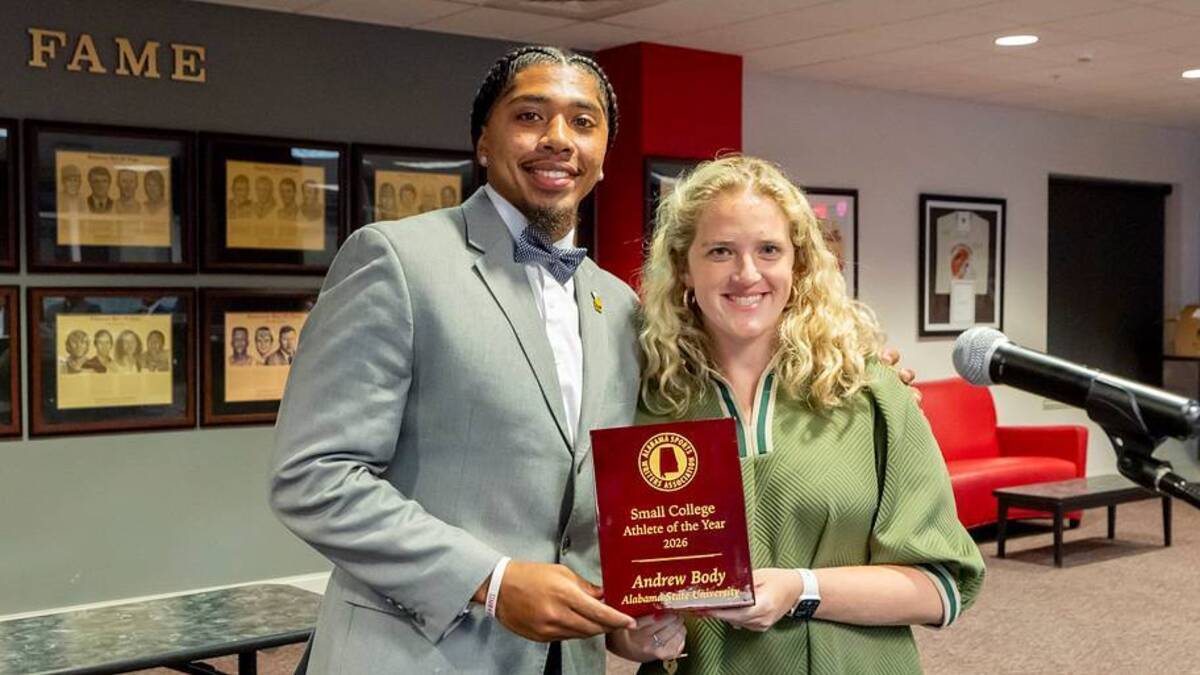  New Alabama Sports Writers Association president Katie Windham presents the Small College Player of the Year trophy to Alabama State quarterback Andrew Body at the ASWA awards banquet on June 14, 2026 at Jacksonville State. | Vasha Hunt 