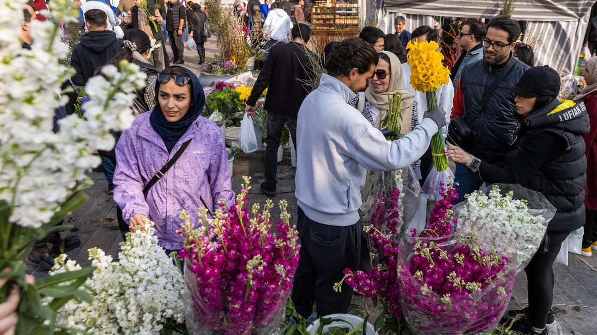 People shop for flowers at a market ahead of Nowruz celebrations on March 19, 2026, in Tehran, Iran. (Majid Saeedi/Getty Images/TNS)