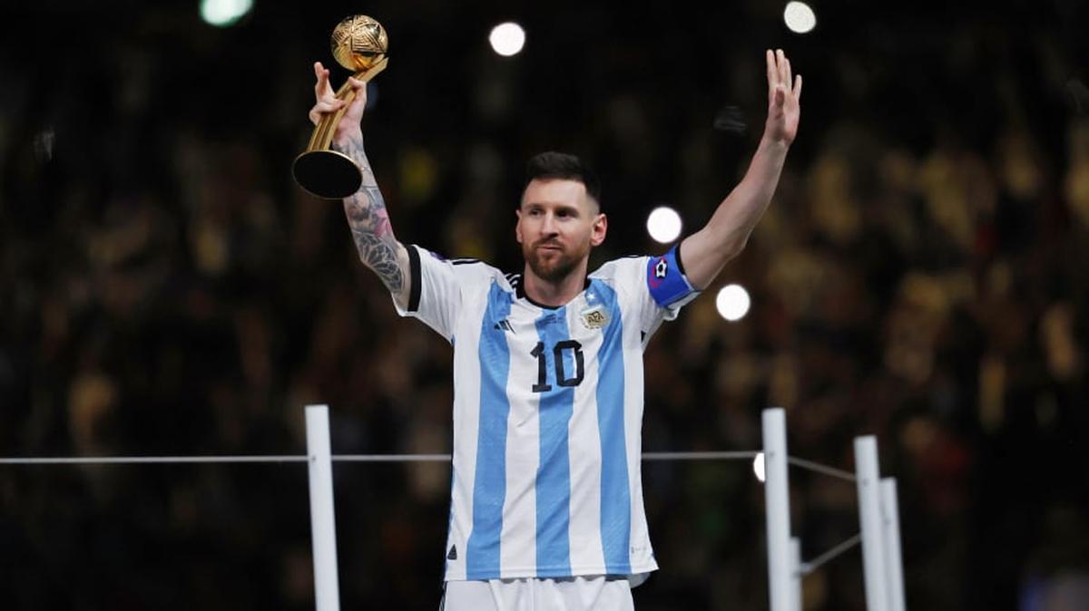 Argentina forward Lionel Messi holds the golden ball trophy in Qatar on Dec. 18, 2022.