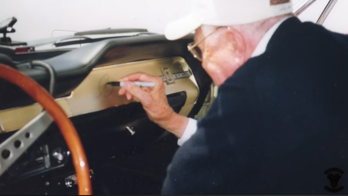  Carroll Shelby signing the GT350's dashboard