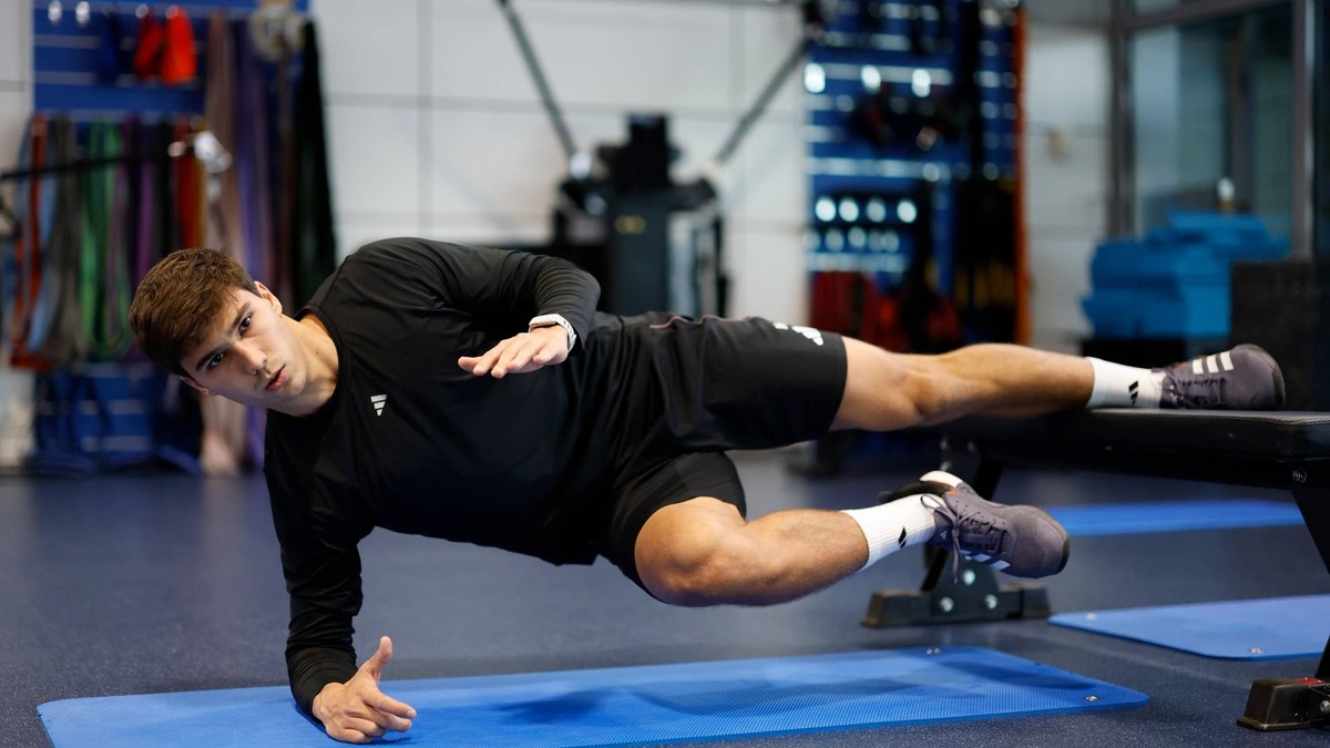 athletes performing the copenhagen plank exercise.