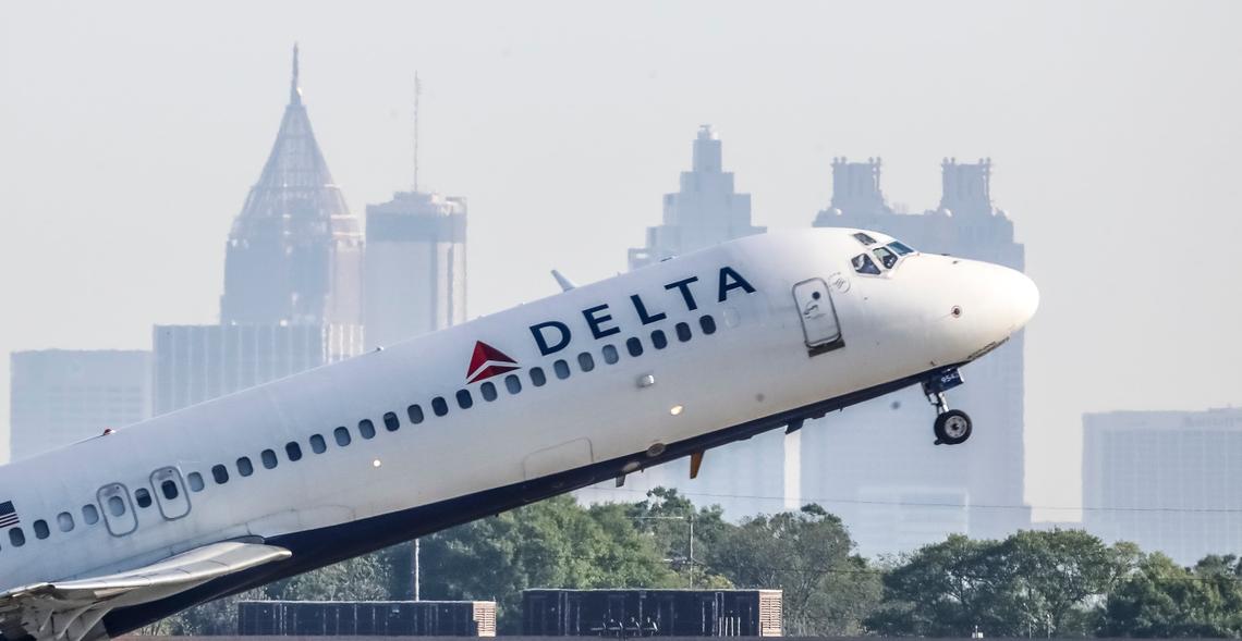 A Delta Air Lines jet takes off with the skyline of Atlanta behind it on April 27, 2021. (John Spink/John.Spink@ajc.com)