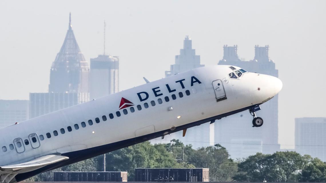 A Delta Air Lines jet takes off with the skyline of Atlanta behind it on April 27, 2021. (John Spink/John.Spink@ajc.com)
