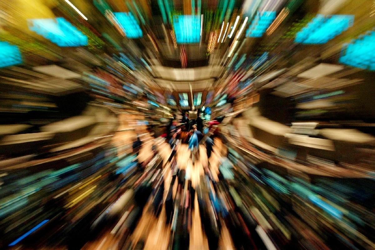FILE PHOTO: Traders work on the floor of New York Stock Exchange December 30, 2003, shortly after the opening bell in this time exposed photo. REUTERS/Jeff Christensen/File Photo