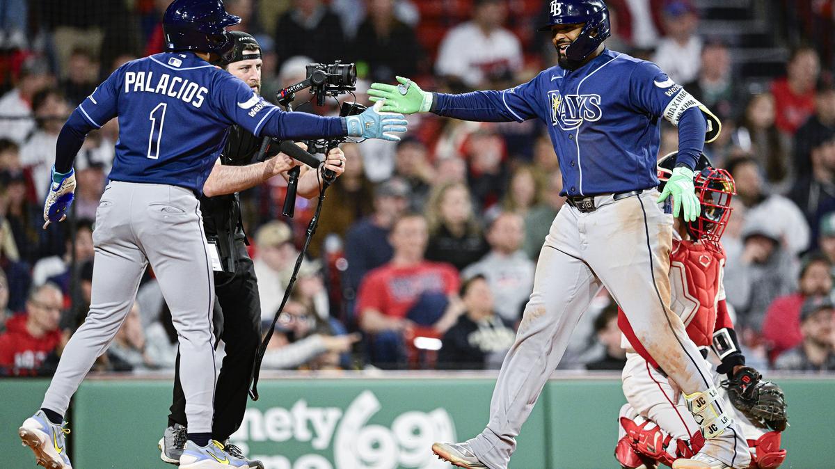 The Tampa Bay Rays' Junior Caminero is greeted at home plate by Richie Palacios (1) after hitting a two-run home run during the ninth inning against the Boston Red Sox at Fenway Park on Thursday, May 7, 2026, in Boston. (Jaiden Tripi/Getty Images/TNS)