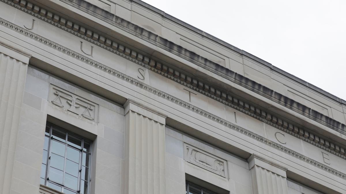 The word "justice" is seen engraved at the headquarters of the United States Department of Justice (DOJ) in Washington, D.C., U.S., May 10, 2021. REUTERS/Andrew Kelly