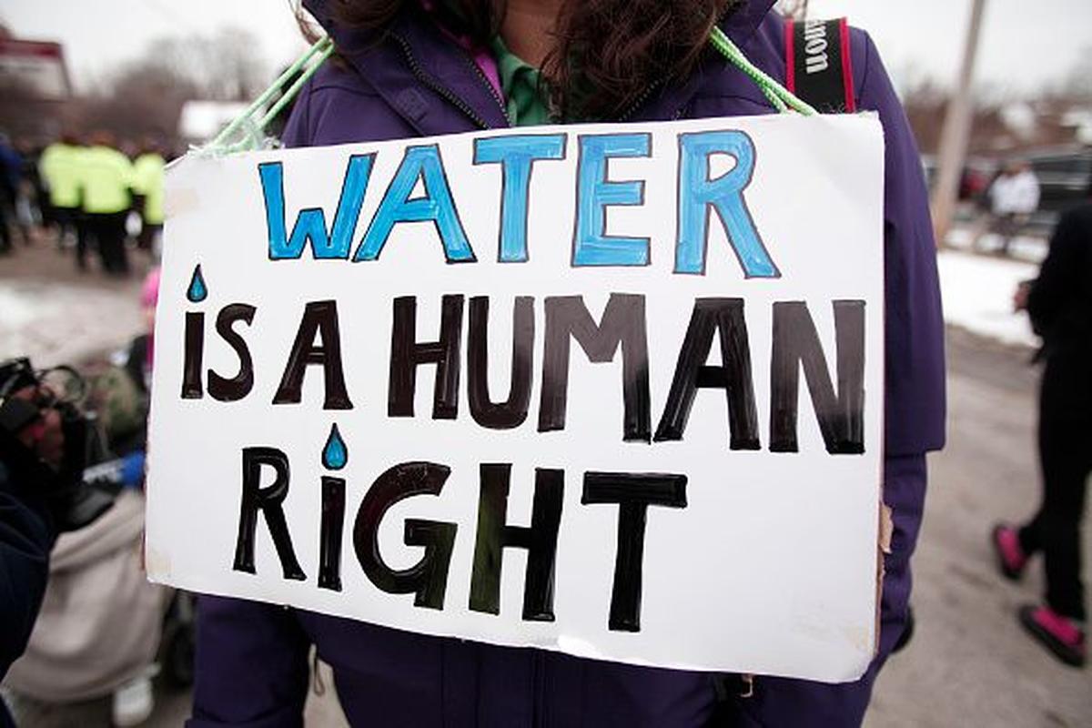  People gather in front of a church before participating in a national mile-long march to highlight the push for clean water in Flint February 19, 2016 in Flint, Michigan. The city commemorated the fifth anniversary of the water crisis on April 25. 