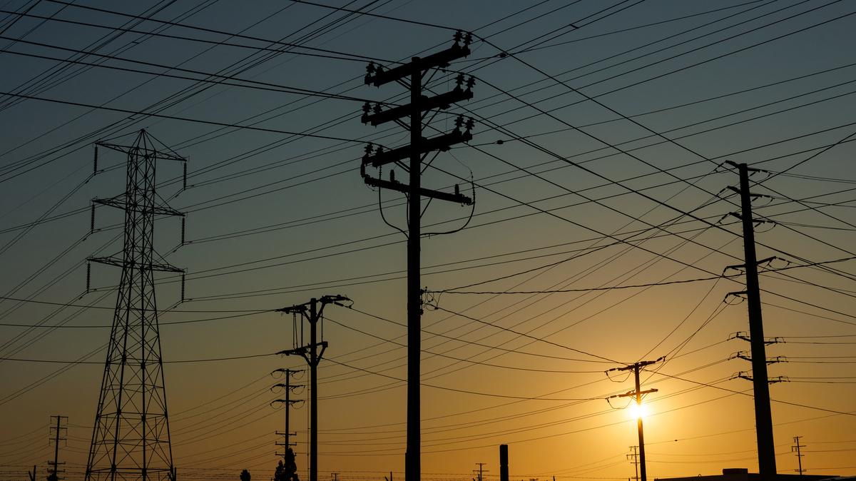 Electrical transmission towers, poles and lines are shown in the early morning of a hot summer day in Commerce, California, U.S, August 7, 2025.  REUTERS/Mike Blake
