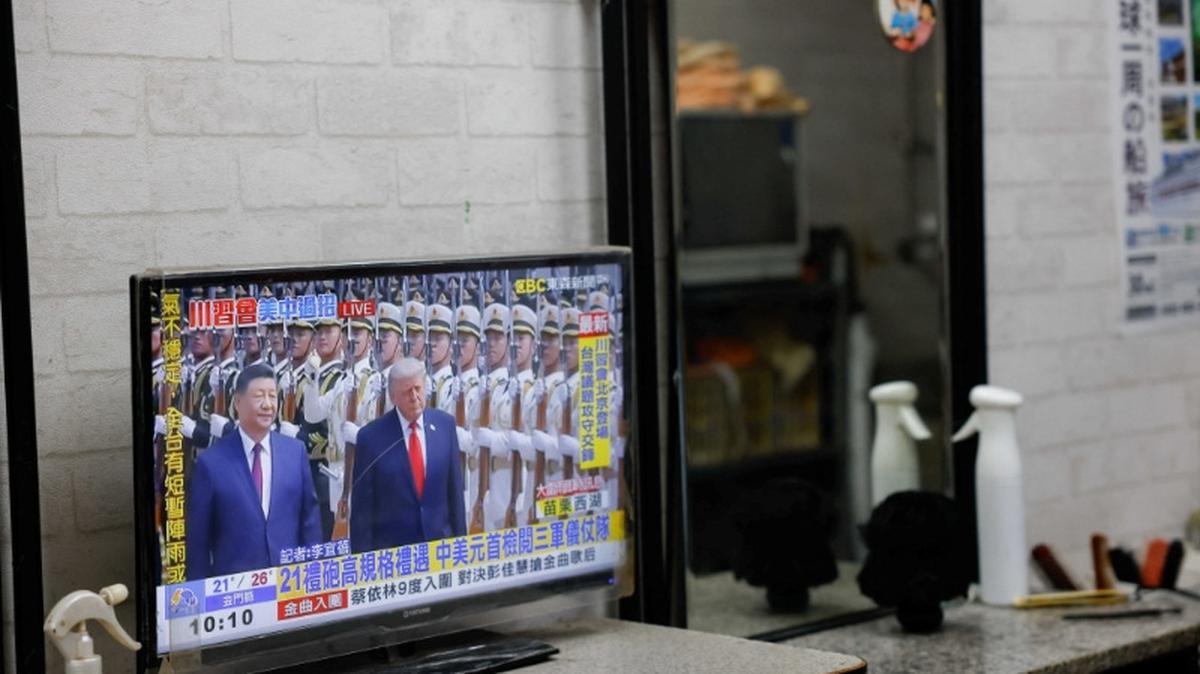 A television screen shows a live broadcast of a meeting between U.S. President Donald Trump and Chinese President Xi Jinping, at a hair salon in Taipei, Taiwan, May 14, 2026. REUTERS/Ann Wang