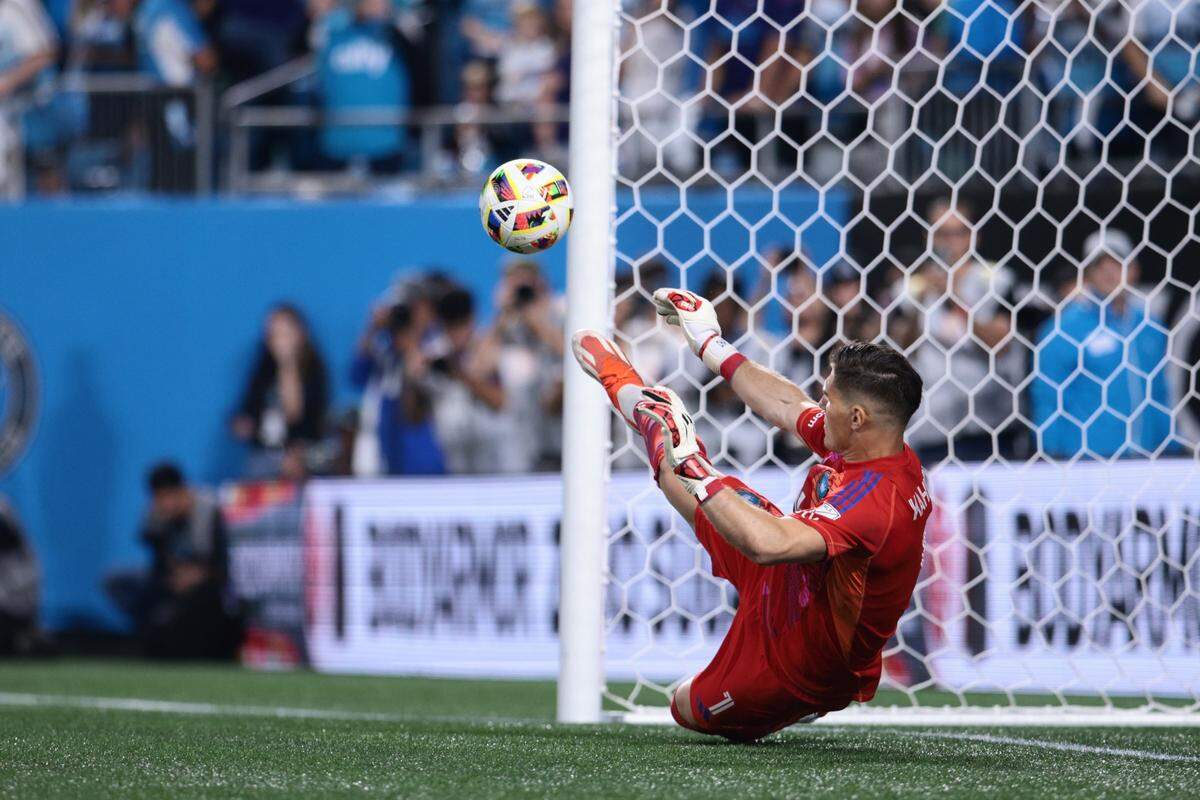 Nov 1, 2024; Charlotte, North Carolina, USA; Charlotte FC goalkeeper Kristijan Kahlina (1) blocks a s penalty shootout kick by Orlando City at Bank of America Stadium.