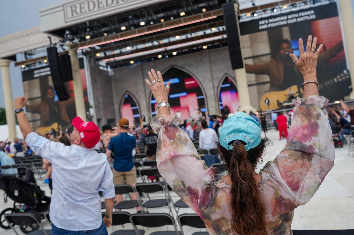 An attendee wearing a "Donald Trump" hat participates in Rededicate 250: National Jubilee of Prayer, Praise & Thanksgiving on the National Mall in Washington, D.C., U.S., May 17, 2026. REUTERS/Eric Lee