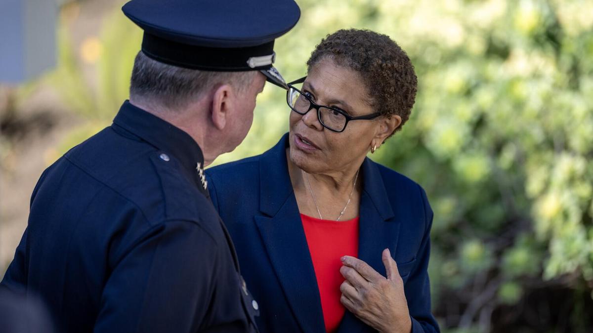 Los Angeles, CA - January 7: Los Angeles Police Chief Jim McDonald, left, speaks with Los Angeles Mayor Karen Bass after a private ceremony where they remembers the fire victims with faith leaders, LAPD officers and city officials as flags were lowered outside City Hall to commemorate the one-year anniversary of the Eaton and Palisades fires in Los Angeles on Wednesday, Jan. 7, 2026. (Allen J. Schaben / Los Angeles Times)