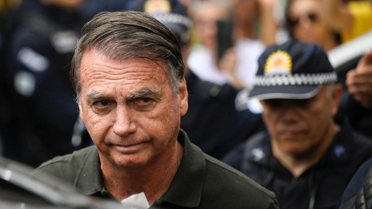 Former Brazilian President Jair Bolsonaro leaves the hospital where he went to undergo a skin surgery procedure, authorized by Supreme Court Justice Alexandre de Moraes, leaving the house arrest after being convicted by a Supreme Court majority of plotting a coup to remain in power after losing the 2022 election, in Brasilia, Brazil, September 14, 2025. REUTERS/Mateus Bonomi/File Photo