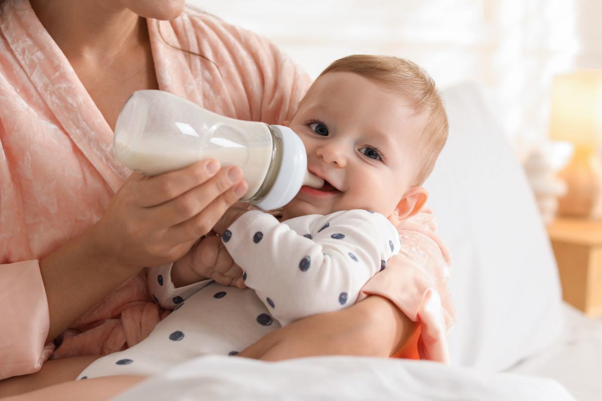  Stock image of a woman bottle feeding a baby. 