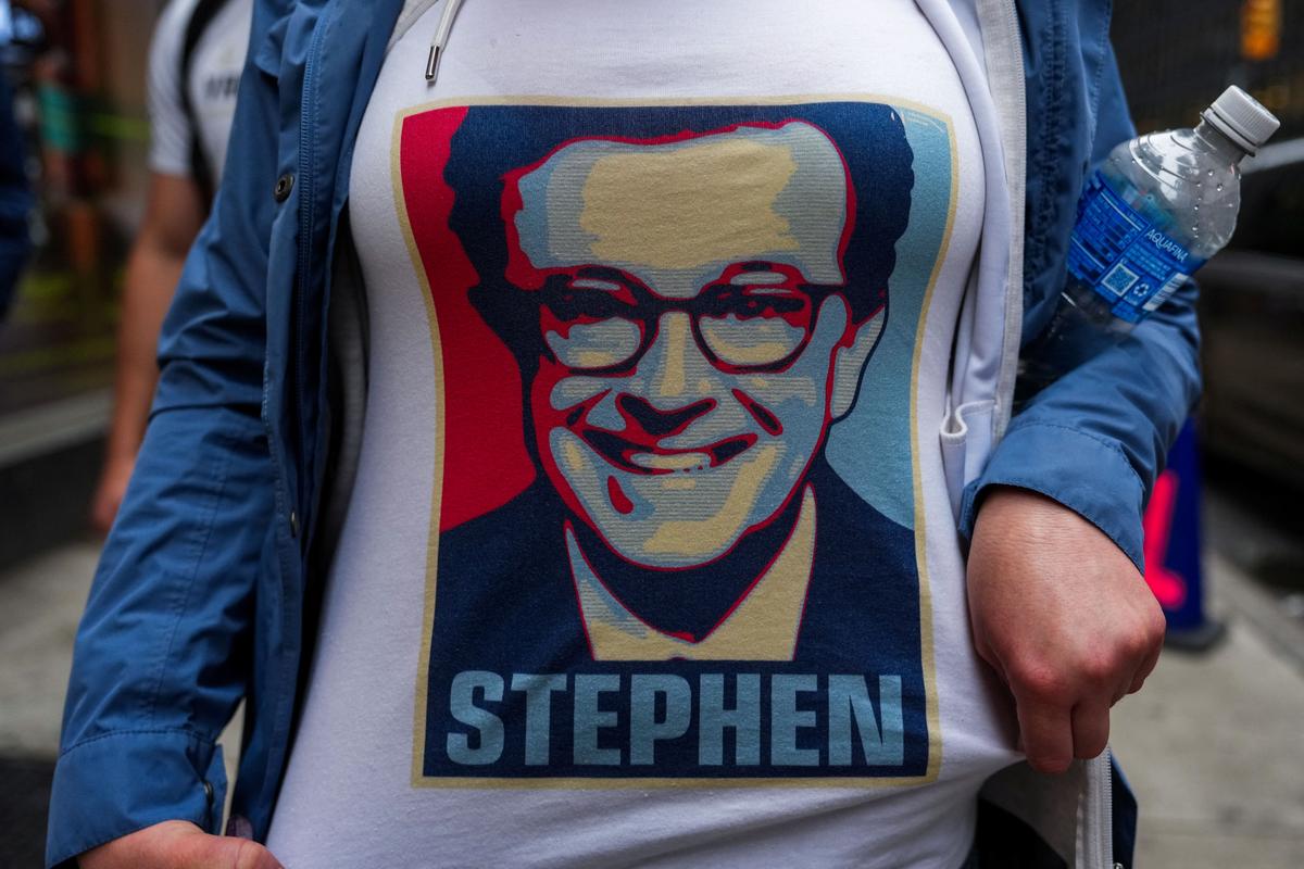 A person wears a t-shirt with an image of Stephen Colbert outside of the Ed Sullivan Theater where the last show of Stephen Colbert’s Late Show is filmed, in New York City, U.S., May 21, 2026. REUTERS/Adam Gray