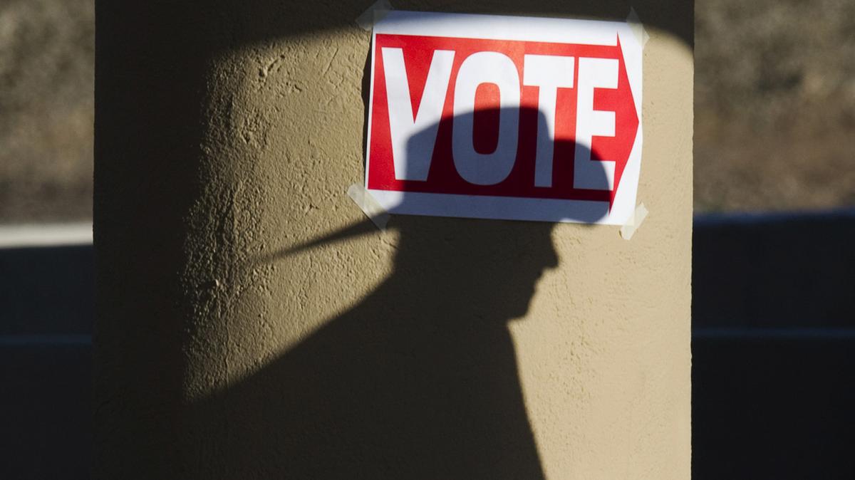 A shadow of a man wearing a cowboy hat falls on a pillar as he enters the polling place at Wickenburg Community Center Feb. 28, 2012, in Wickenburg, Arizona. (Don Emmert/AFP/Getty Images/TNS)
