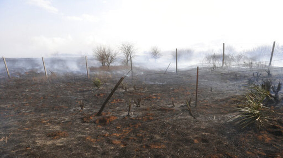 Ground is scorched after a fire north of Harper Kans., Tuesday, March 6, 2018. Flames driven by winds gusting up to 50 mph hamper efforts of units from several surrounding towns.