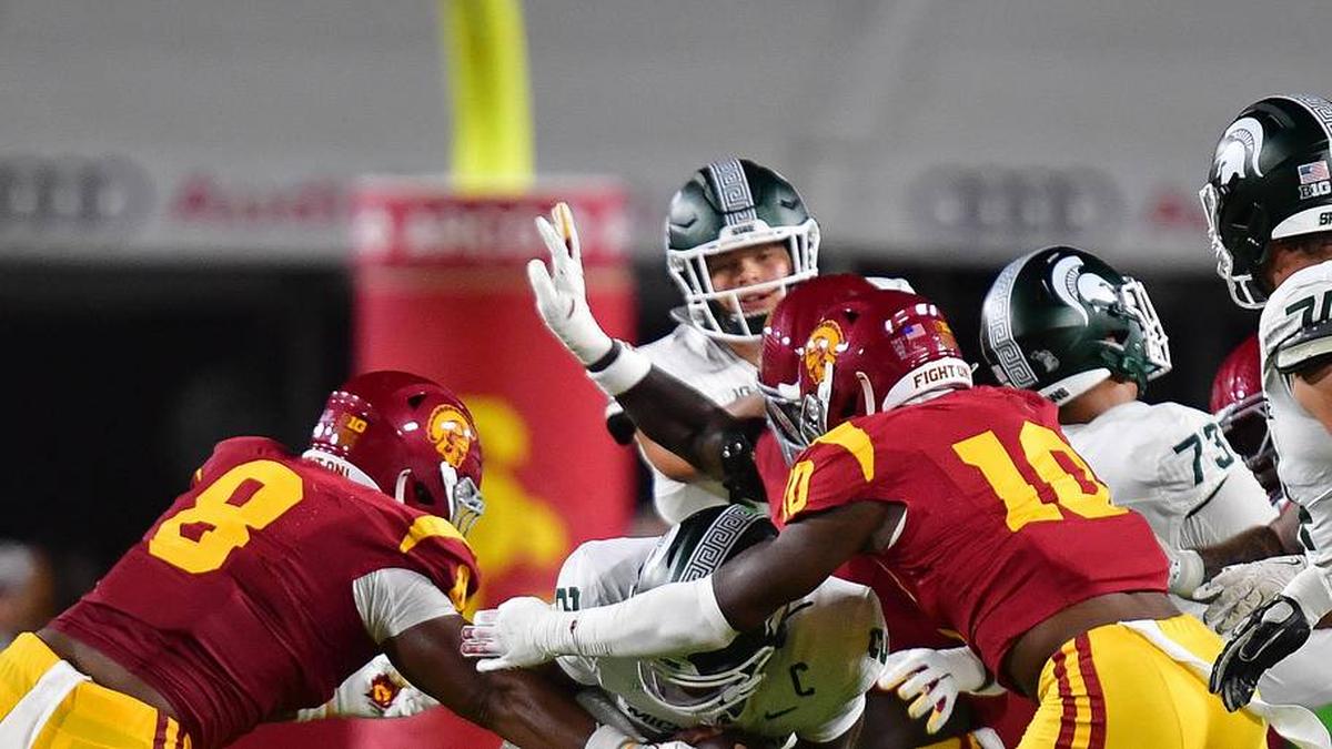  Sep 20, 2025; Los Angeles, California, USA; Michigan State Spartans quarterback Aidan Chiles (2) is brought down by Southern California Trojans defensive tackle Devan Thompkins (8) and defensive end Braylan Shelby (10) during the first half at the Los Angeles Memorial Coliseum. Mandatory Credit: Gary A. Vasquez-Imagn Images | Gary A. Vasquez-Imagn Images 