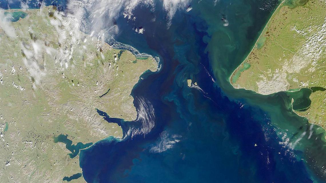 A summertime satellite view provided by NASA shows the Bering Strait, which separates northeastern Russia and Alaska. Blocking the narrow waterway between Russia and Alaska could help stabilize a vulnerable system of ocean currents, scientists found in a study.