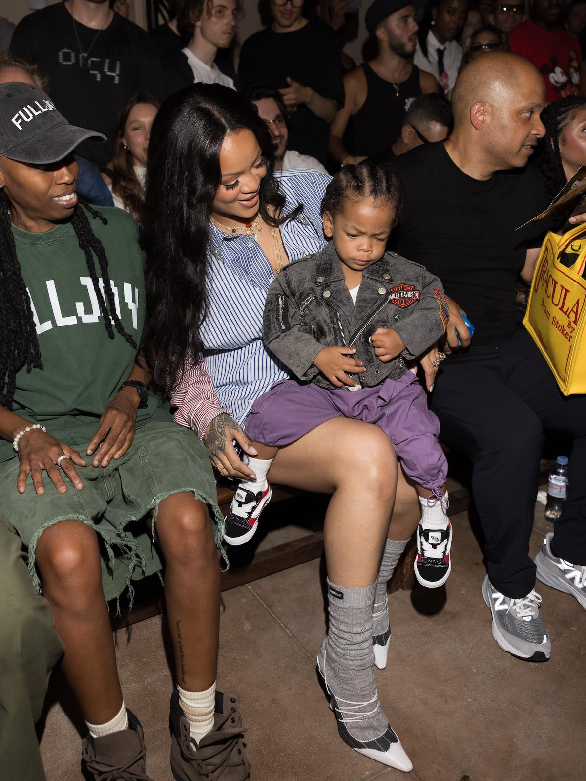 Rihanna and son Riot Rose sit in the front row of the AWGE Menswear Spring/Summer 2026 show on Friday, June 27.