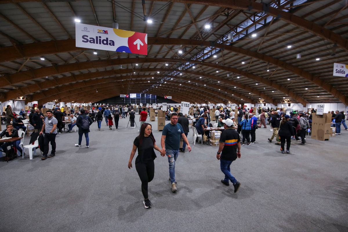 People walk at Colombia's largest polling station, called Corferias, during a runoff between right-wing presidential candidate Abelardo De La Espriella and leftist candidate Ivan Cepeda, in Bogota, Colombia, June 21, 2026. REUTERS/Juan David Duque