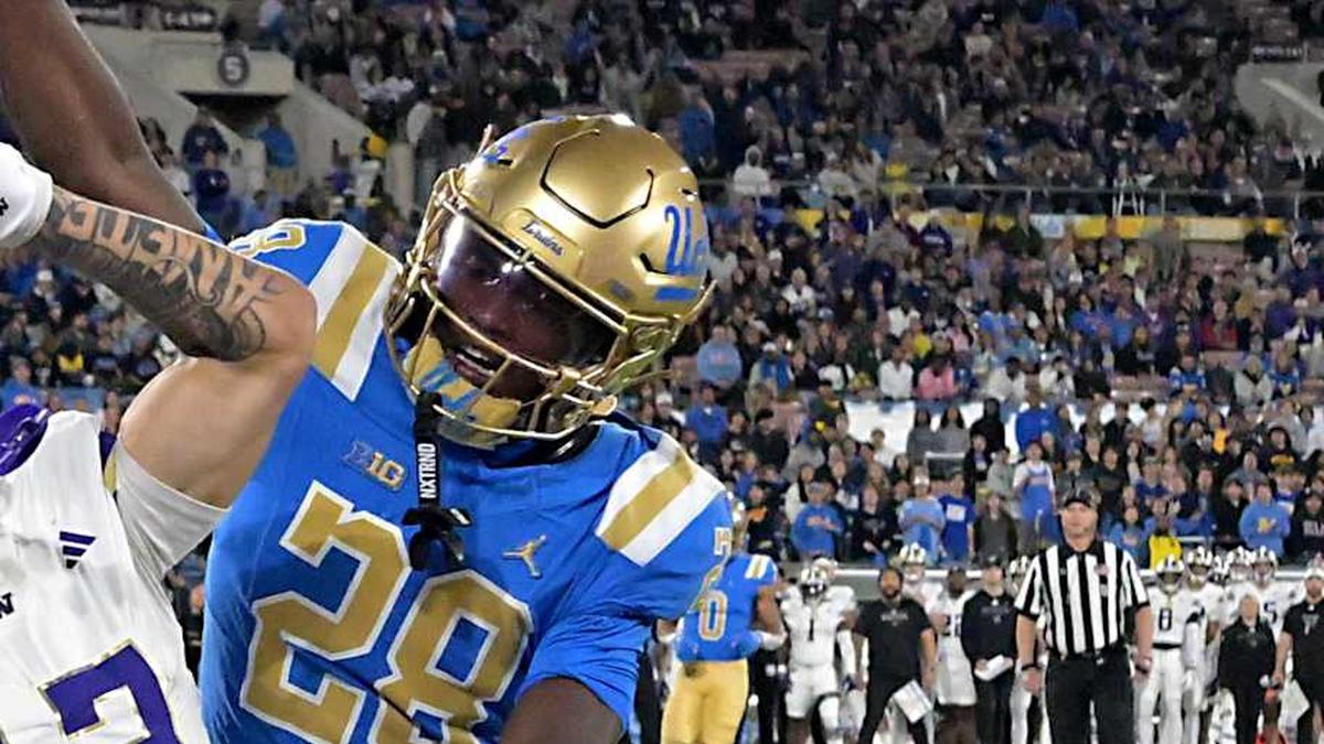  Nov 22, 2025; Pasadena, California, USA; UCLA Bruins defensive back Scooter Jackson (28) breaks up a pass intended for Washington Huskies wide receiver Audric Harris (13) in the end zone during the first half at the Rose Bowl. Mandatory Credit: Jayne Kamin-Oncea-Imagn Images | Jayne Kamin-Oncea-Imagn Images 