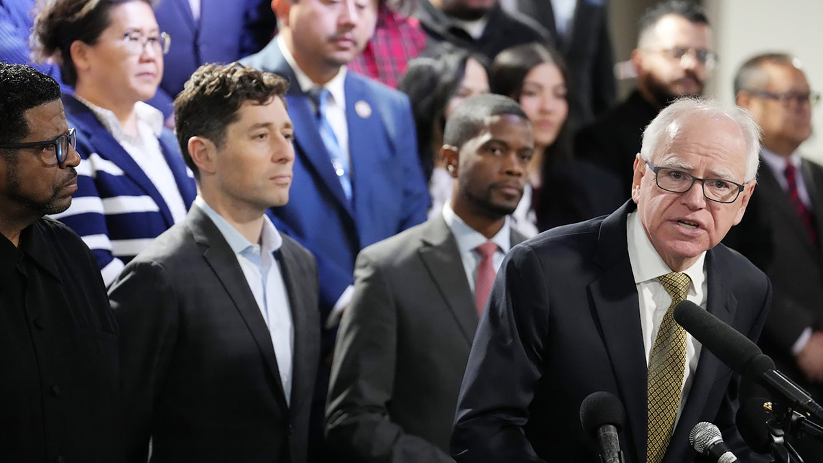 Gov. Tim Walz speaks during a press conference with Minneapolis Mayor Jacob Frey, then-St. Paul Mayor Melvin Carter, then-St. Paul Mayor-elect Kaohly Her, Bishop Richard D. Howell, Jr, and fellow community leaders to address recent federal immigration enforcement efforts in Minnesota amid an increased ICE presence and targeting of U.S. citizens in the state Tuesday, Dec. 23, 2025, at Shiloh Temple in north Minneapolis. (Anthony Souffle/The Minnesota Star Tribune/TNS)