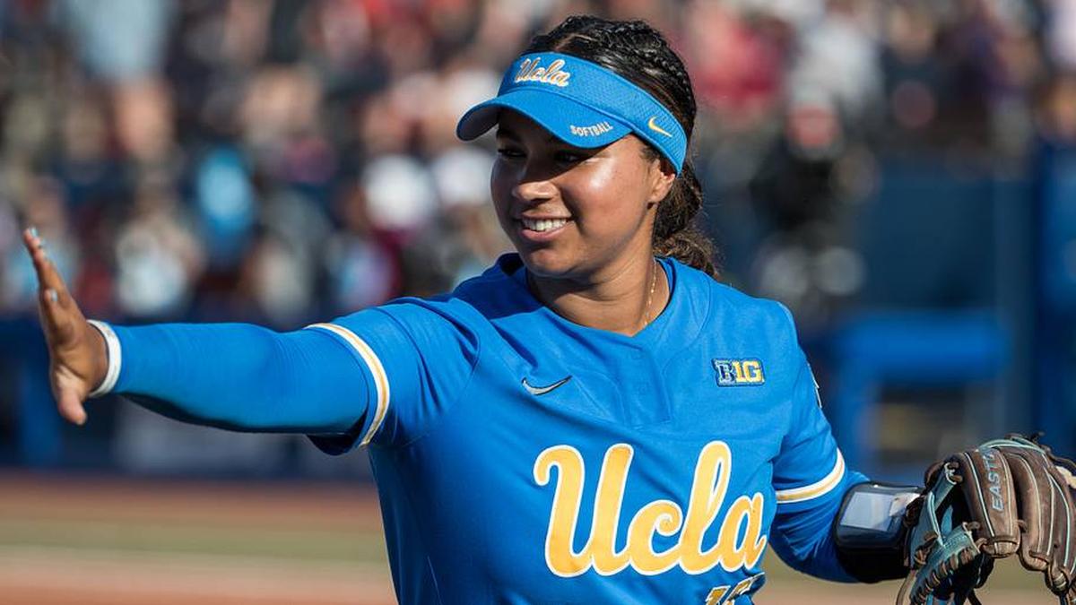  May 31, 2025; Oklahoma City, OK, USA; UCLA Bruins infielder Jordan Woolery (15) reaches out to slap hands with a teammate in the first inning against the Texas Tech Red Raiders during the NCAA Softball Women's College World Series at Devon Park. Mandatory Credit: Brett Rojo-Imagn Images | Brett Rojo-Imagn Images 
