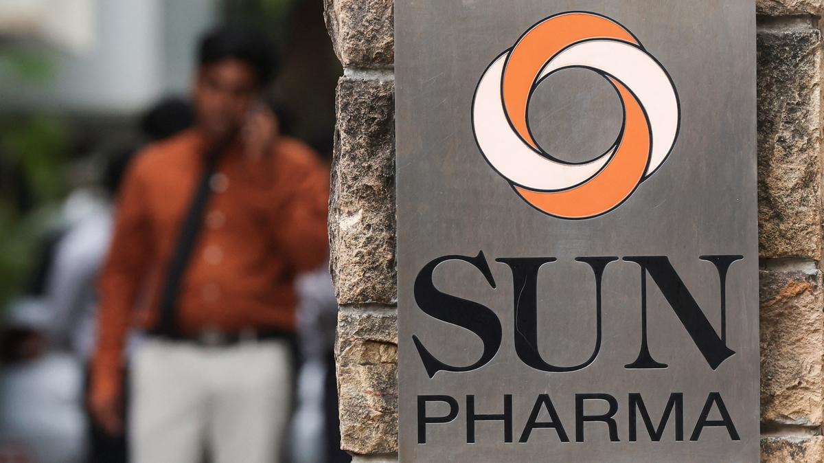A man speaks on his phone next to the logo of Sun Pharmaceutical Industries Ltd., in Mumbai, India, October 31, 2025. REUTERS/Francis Mascarenhas