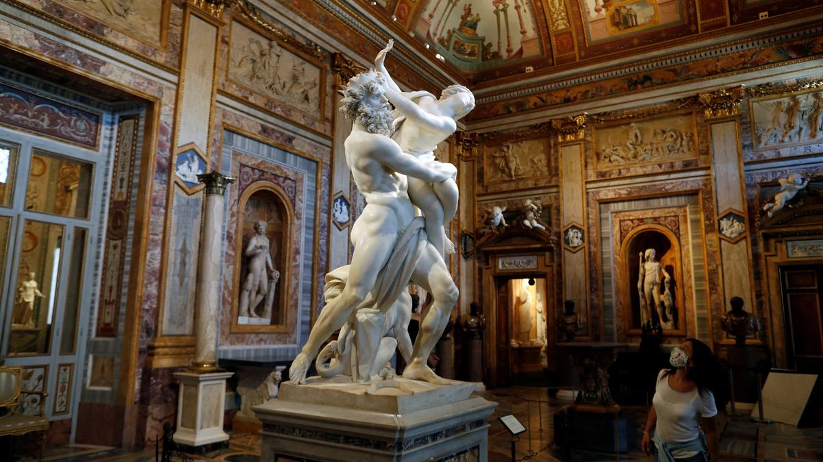 FILE PHOTO: A visitor looks at a statue inside Galleria Borghese, in Rome, Italy, May 22, 2020. REUTERS/Yara Nardi/File Photo