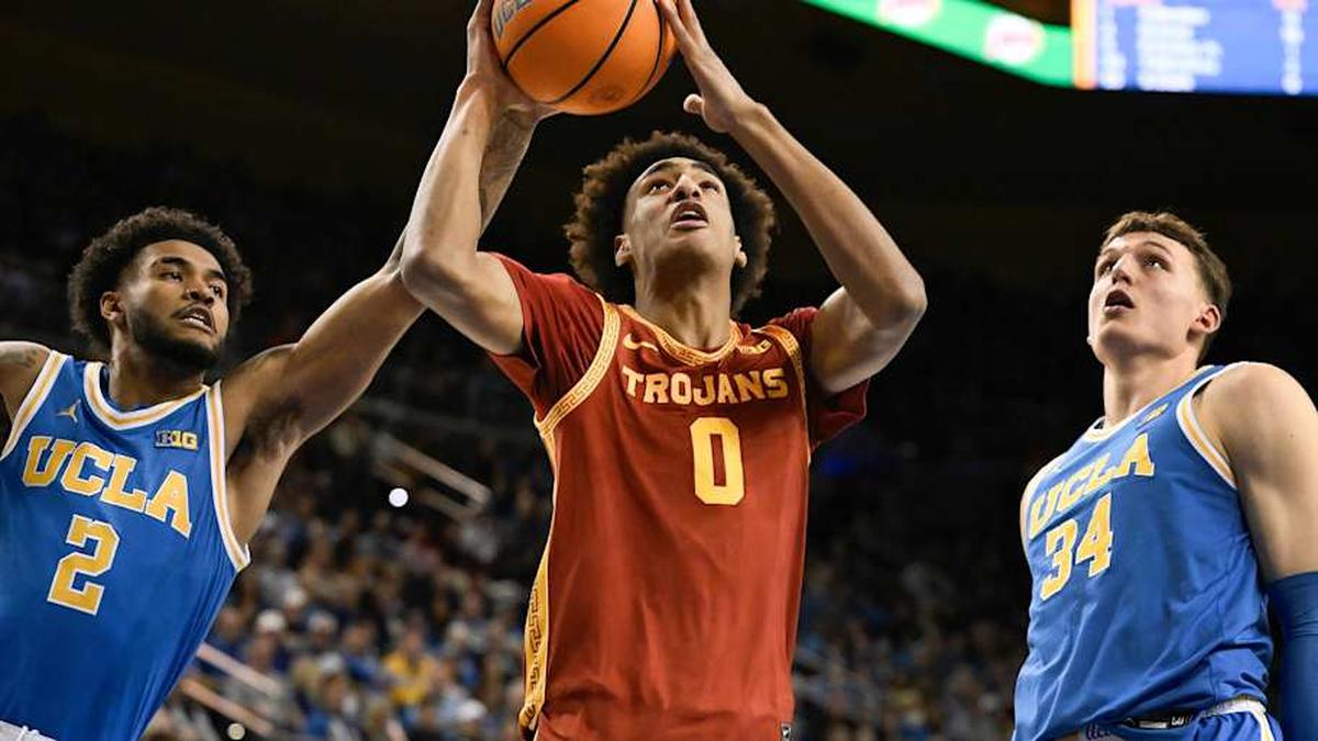  Feb 24, 2026; Los Angeles, California, USA; Southern California Trojans guard Alijah Arenas (0) drives to the basket past UCLA Bruins guard Donovan Dent (2) and forward Tyler Bilodeau (34) during the first half at Pauley Pavilion presented by Wescom Financial. Mandatory Credit: Robert Hanashiro-Imagn Images | Robert Hanashiro-Imagn Images 