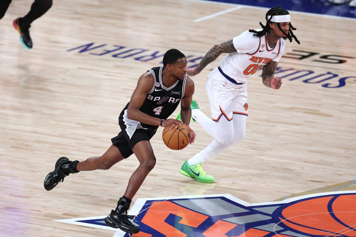  Jun 8, 2026; New York, New York, USA; San Antonio Spurs guard De'aaron Fox (4) controls the ball against New York Knicks guard Jordan Clarkson (00) in the fourth quarter during game three of the 2026 NBA Finals at Madison Square Garden. Mandatory Credit: Vincent Carchietta-Imagn Images 