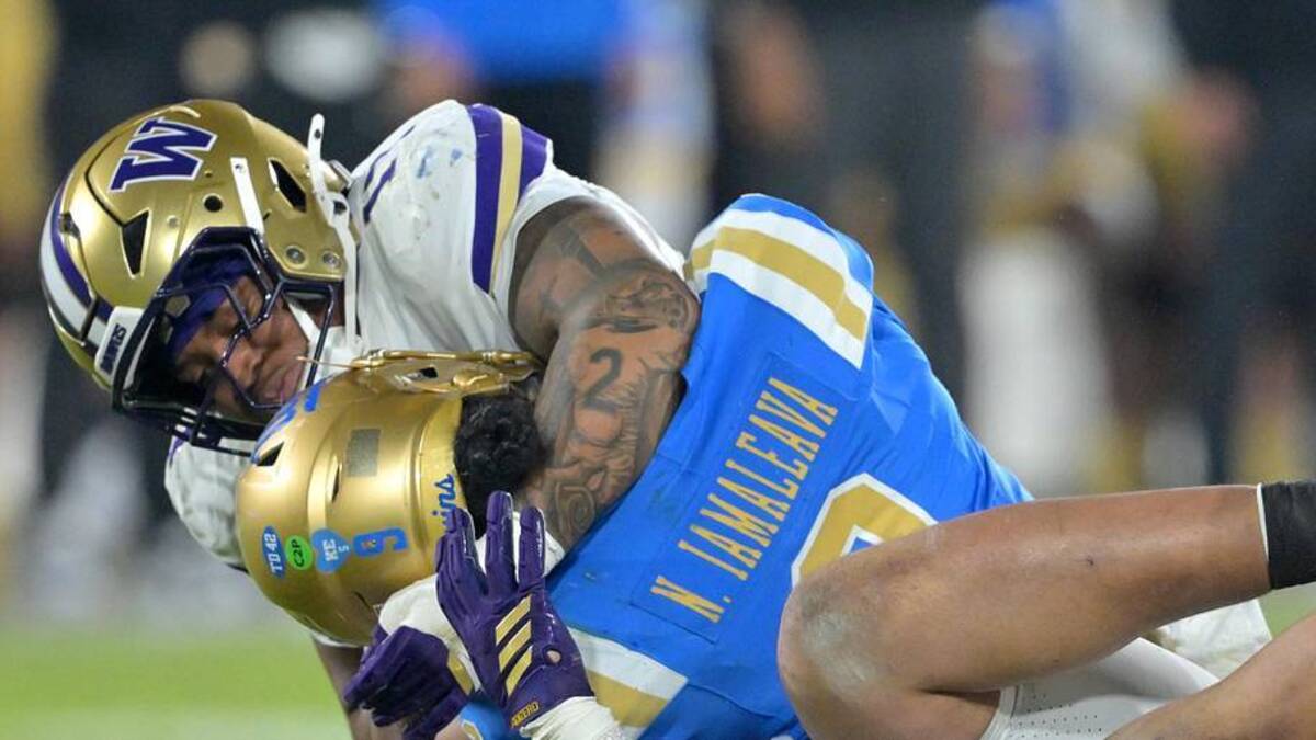  Nov 22, 2025; Pasadena, California, USA; UCLA Bruins quarterback Nico Iamaleava (9) is sacked by Washington Huskies linebacker Deven Bryant (17) and defensive lineman Bryce Butler (92) during the second half at the Rose Bowl. Mandatory Credit: Jayne Kamin-Oncea-Imagn Images | Jayne Kamin-Oncea-Imagn Images 